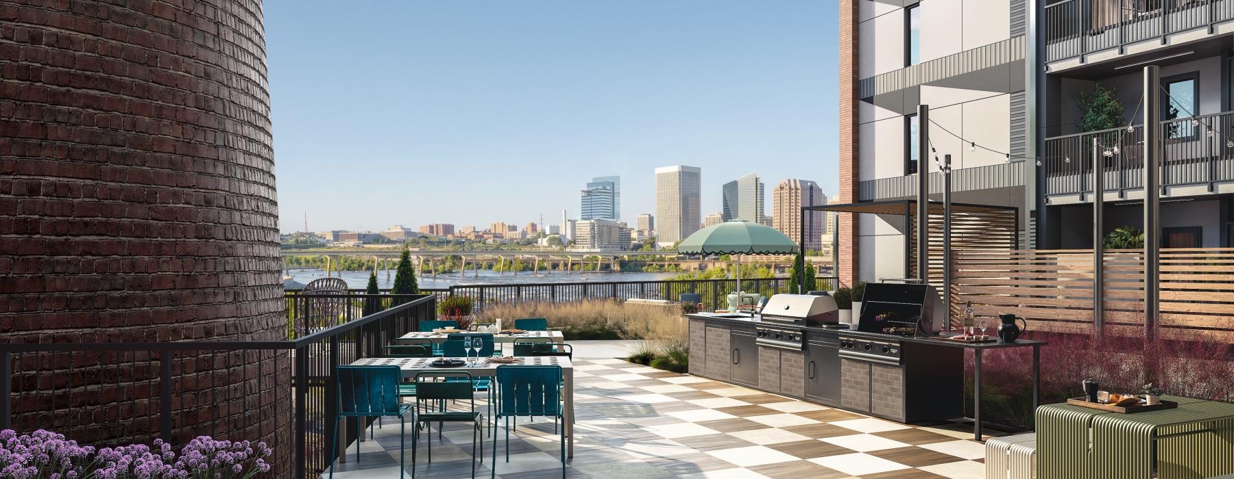 a patio with tables and chairs and a body of water in the background